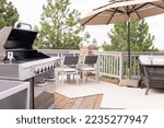 Small photo of Outdoor six-burner gas grill on the back patio of a luxury single-family home.