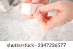 Small photo of Woman finishing her manicure at home with simple manicure tools. Buffering nails with a nail buffer block.
