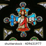 Small photo of PRAGUE, CZECH REPUBLIC - APRIL 2, 2016: Stained Glass window in St. Vitus Cathedral, Prague, depicting Jesus Christ holding the bible with Greek Letters Alpha and Omega.