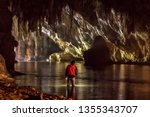 Tourists Explore The Cave Of...