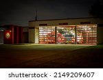 Small photo of Plano, Texas, USA - April 16th, 2022: Ready-to-move fire trucks in Fire Station 2 at night