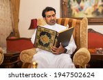 Arab Muslim man reading the holy book the Quran Kareem

