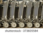 Small photo of Baggage car of a luggage cart rental are consecutively ranked on the sidewalk and the entrance of an airport / Baggage car rental