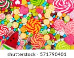 Colorful lollipops and different colored round candy. Top view.