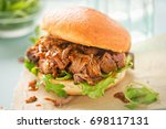 Pulled pork sweet bun with mixed lettuce leaves