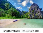 Girl at Hidden Beach in Matinloc Island, El Nido, Palawan, Philippines - Tour C route - Paradise lagoon and beach in tropical scenery