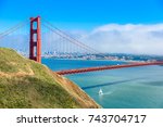 Golden Gate Bridge with the skyline of San Francisco in the background on a beautiful sunny day with blue sky and clouds in summer - Panoramic view from Battery Spencer - California, USA
