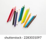 Bunch of fun mini colored pencils isolated on white. Multicolor group of cute small wooden pencils