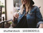 happy blonde woman enjoying white wine and smiling