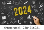 Small photo of 2024 written on a blackboard with icons