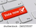 A keyboard with a red button - Vote now