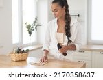 young woman cleans the kitchen... | Shutterstock . vector #2170358637