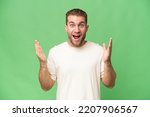 Young handsome caucasian man isolated on green chroma background with surprise facial expression