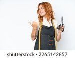 Young caucasian seamstress woman isolated on white background pointing to the side to present a product
