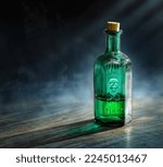 Small photo of Glass poison bottle with skull and bones. Danger sign, symbol of death. Concept background on poison poisoning, chemistry, pharmacy, medical topic. Poison, venom, toxin, toxic, bane, virus background.