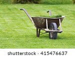 Old Wheelbarrow On A Lawn With...