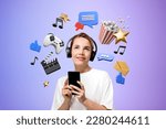 Portrait of smiling young woman using smartphone and headphones standing over purple background with online entertainment icons