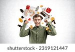 Small photo of Happy man with arms raised, looking at the camera with casino jackpot and slot machine on grey concrete wall background. Concept of big win, luck and gambling
