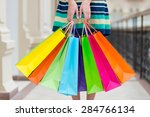 Woman holding colourful shopping bags at the mall.