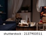 Small photo of Nobody in living room with messy rubbish cans and leftovers food on table. Empty home space with beer bottles, trash, dirty garbage covered in unhealthy snacks. Stinky unorganized place.