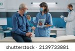 Small photo of Nurse and elder patient looking at cardiology illustration on digital tablet during coronavirus pandemic. Woman and man analyzing cardiovascular system and heart condition on screen.
