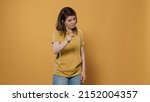 Small photo of Angry upset woman arguing showing index finger pointing at guilty person punishing mischief in studio. Shouting girl looking unhappy and displeased asking for obedience and demanding respect.