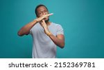 Small photo of Serious tired person advertising timeout symbol with hands, doing t shape sign to express half time and break. Exhausted man refusing to work, declining and ingoring control. Stop gesture.