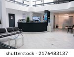 No people in waiting area for patients with doctor appointments in modern healthcare clinic in private practice hopital. Empty waiting room with front desk reception with promotional flyers.