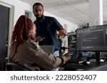 African american engineers typing machine learning html code on computer, sitting at desk table in big data office. Software developers working on database system with html script in it security