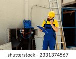 Small photo of Seasoned mechanic on the phone with customer reporting found issues on outdoor hvac system after thorough inspection. Worker going over air conditioner insurance details with client while on call