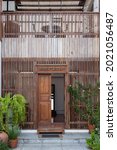 Small photo of Wooden slats is wallpaper in front door and green tree leaf .design of Thailand local house.