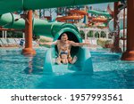 Father playing with his daughter in swimming pool. Funny family weekend. Father and daughter enjoy time together in water park. 
