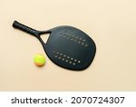 Black professional beach tennis racket and ball on beige background. Horizontal sport theme poster, greeting cards, headers, website and app