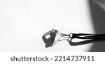 Small photo of Sports whistle on grey background. Concept- sport competition, referee, statistics, challenge. Basketball, handball, futsal, volleyball, soccer, baseball, football and hockey referee whistle