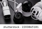 Small photo of Surveillance cameras, set of different videcam, cctv cameras isolated on black background close up. home security system concept