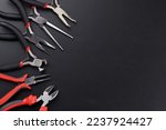 Set of different types of pliers and side cutters isolated on black background. Hand tools for repair, construction and maintenance