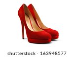 A pair of red female shoes on a white background.