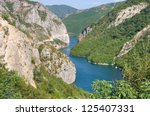 blue water of Koman-Fierza Lake between steep cliffs, Albania