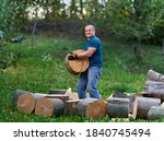 Small photo of Strong lumberjack manhandling the logs