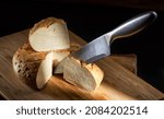 Small photo of A truckle of matured cheese homemade on a wooden board