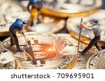 macro miner figures working on group of bitcoins. virtual cryptocurrency mining concept