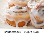Delicious freshly baked cinnamon rolls on decorative plate.  Macro of 'mini' rolls with extremely shallow dof.