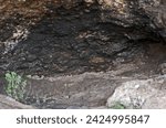 Small photo of ENTRANCE OF A CAVE WITH A BLACKENED ROOF