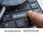 Job Vacancy, computer keyboard, magnifying glass. Human resource business concept.