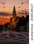 Small photo of New Town Hall in Olsztyn and Pilsudskiego Street with tracks and electrification lines of city trams, view after sunset