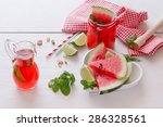Fresh watermelon with juice and pistachio.   Watermelon fruit drink with pistachio, mint, lime and  fresh watermelon slice in heart shape bowl. .Macro, selective focus, natural light 