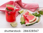 Fresh watermelon with juice. Healthy organic watermelon snack in jar  and  fresh watermelon slice in heart shape bowl.. Macro, selective focus, natural light 