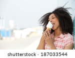 Close up portrait of a young woman licking ice cream outdoors in summer 