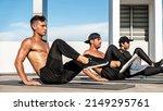 Small photo of Side view of strong shirtless multiracial men doing bicycle crunches on mats during intense training outdoors in the open air rooftop