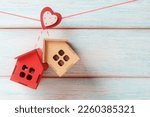 Decorative houses on a rope with a heart-shaped clothespin. Valentine’s day greeting concept